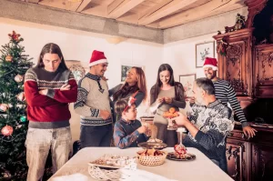 A group of people gathered around a festive holiday table, with one individual dominating the conversation while others appear distant and uncomfortable.