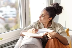 An open journal with a pen and a cup of tea on a cozy table, symbolizing reflection and intention-setting for the New Year.