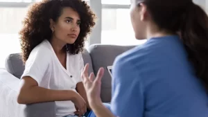 A comforting therapy setting with a soft focus on a chair and cozy ambiance, symbolizing the safe space created for trauma healing through EMDR therapy.