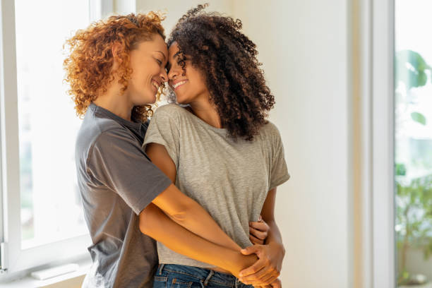 women, same sex couple embracing each other, in love.