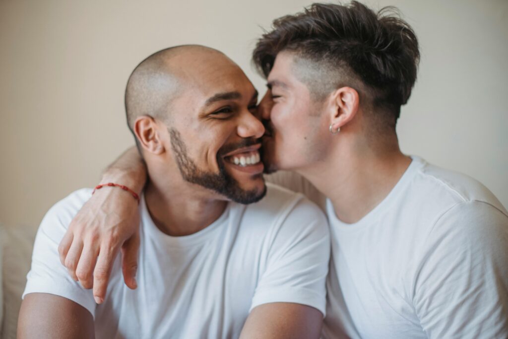 Two men sharing a joyful, affectionate moment, representing emotional safety, connection, and choosing an aligned partner in a healthy relationship.