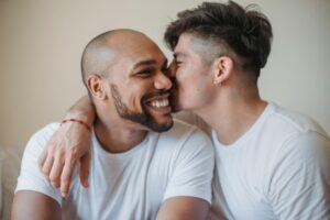Two men sharing a joyful, affectionate moment, representing emotional safety, connection, and choosing an aligned partner in a healthy relationship.
